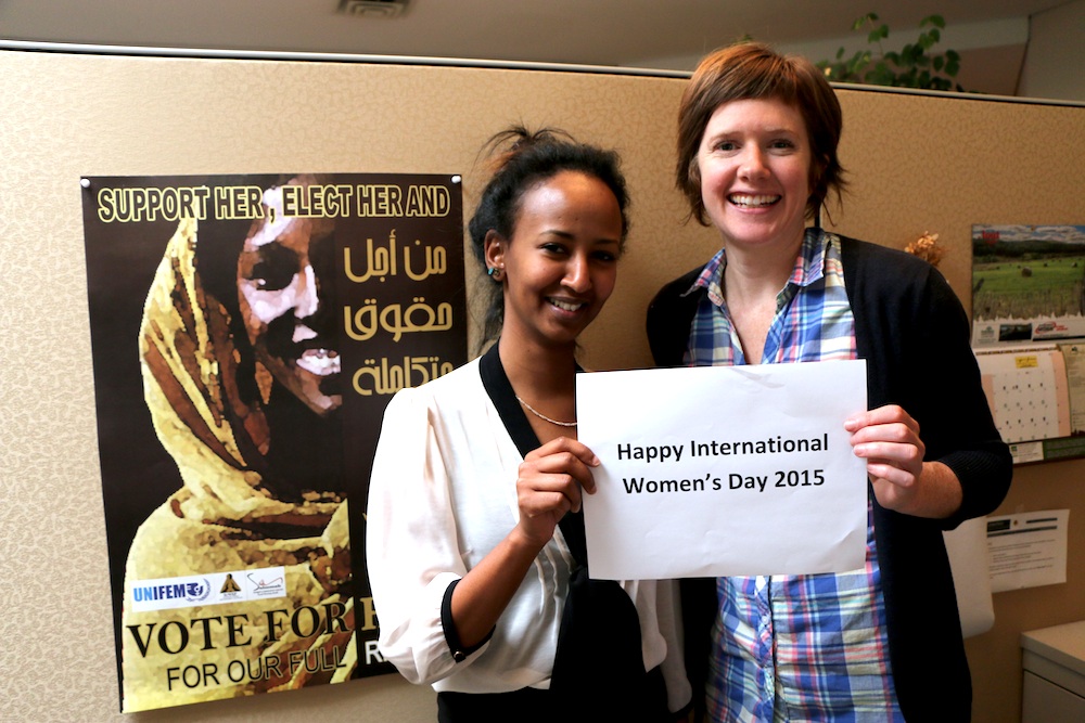 Maha Babeker and Kathryn Dingle with an IWD sign