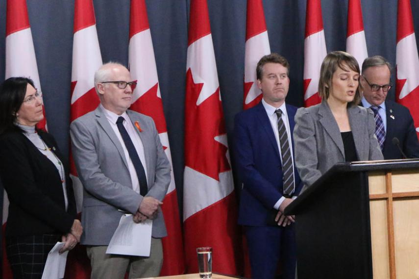 Samantha McGavin joins Amnesty’s Alex Neve and Kyle Matthews of the Montreal Institute for Genocide and Human Rights Studies in pressing for stronger Canadian measures. Also on stage: MPs Cheryl Hardcastle (at left) and Rob Oliphant (at right).