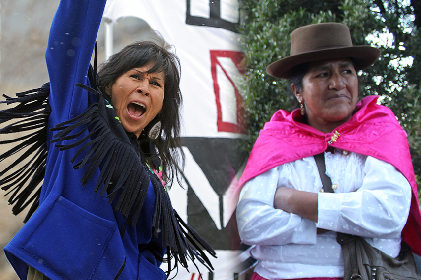 Morningstar Mercredi chants with her right fist in the air at an Idle No More march in Edmonton. Victoria Saccsara stands with her arms crossed and looks over her left shoulder.