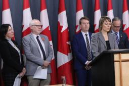 Samantha McGavin joins Amnesty’s Alex Neve and Kyle Matthews of the Montreal Institute for Genocide and Human Rights Studies in pressing for stronger Canadian measures. Also on stage: MPs Cheryl Hardcastle (at left) and Rob Oliphant (at right).