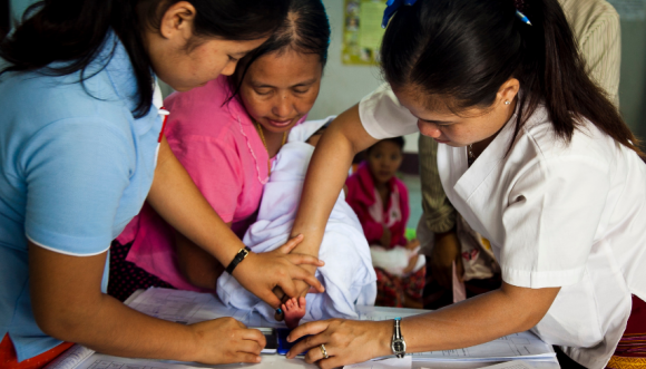 Doctors at the Mae Tao Clinic with a newborn baby